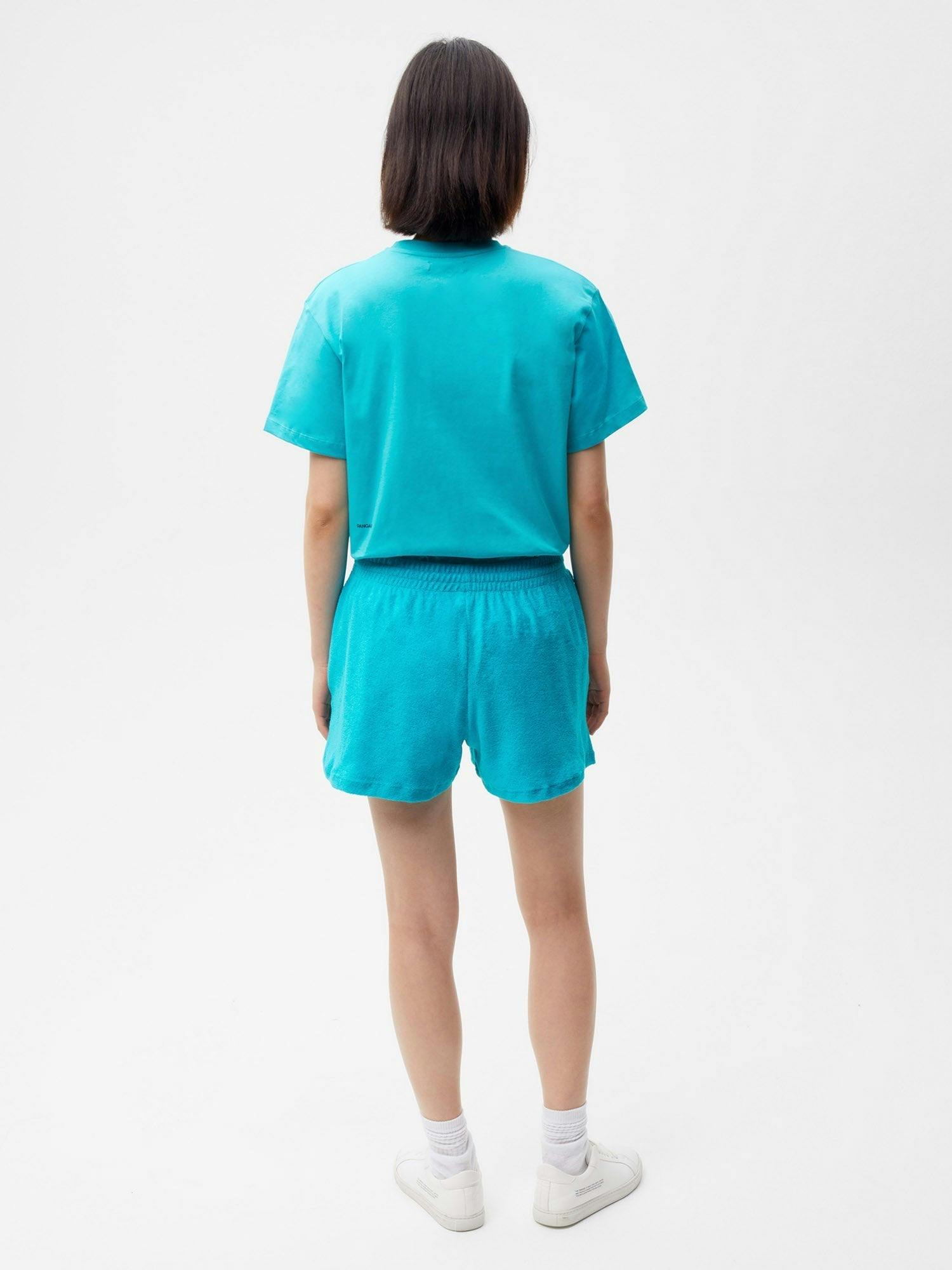 https://cdn.shopify.com/s/files/1/0035/1309/0115/products/Towelling-Organic-Cotton-Short-Shorts-Peacock-Blue-Female-2.jpg?v=1662476500